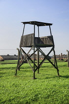 Poland, Auschwitz-Birkenau State Museum, Birkenau Concentration Camp, Guard tower with barbed wire fencing.