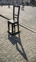 Poland, Krakow, Podgorze area, Plac Bohaterow Getta or Ghetto Heroes Square formerly known as Plac Zgody, Memorial to Jews from the Kraków Ghetto on their deportation site, Each steel chair represent...