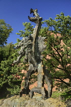 Poland, Krakow, Statue of the Wawel Dragon outside Smocza Jama or the Dragon's Den below Wawel Hill.