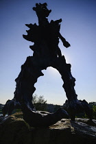 Poland, Krakow, Statue of the Wawel Dragon outside Smocza Jama or the Dragon's Den below Wawel Hill.