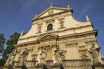 Poland, Krakow, Church of Saints Peter and Paul with statues of the Apostles in the foreground.