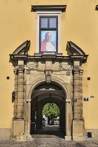 Poland, Krakow, Archbishop's Palace or Palac Biskupi, Palace entrance arch with picture of Saint John Paul 2nd above.