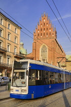 Poland, Krakow, Dominican Church of the Holy Trinity with city tram.