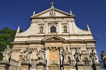 Poland, Krakow, Church of Saints Peter and Paul with statues of the Apostles in the foreground.