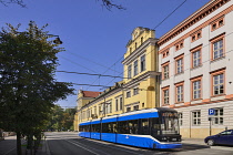 Poland, Krakow, Archbishop's Palace or Palac Biskupi, General view of the facade with city tram passing by.