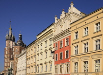 Poland, Krakow, Rynek Glowny or Main Market Square, St Mary's Church also known as St Marys Basilica, with row of houses on the squares east side.