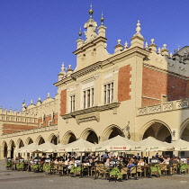 Poland, Krakow, Rynek Glowny or Main Market Square, Evening dining on the west side of the square with Sukiennice or The Cloth Hall.