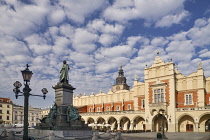 Poland, Krakow, Rynek Glowny or Main Market Square, The Cloth Hall or Sukiennice with a statue of the poet Adam Mickiewicz.