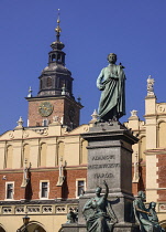 Poland, Krakow, Rynek Glowny or Main Market Square, The Cloth Hall or Sukiennice with a statue of the poet Adam Mickiewicz.