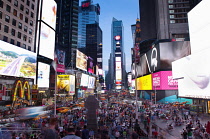 USA, New York State, New York City, Manhattan, Crowds of tourists in illuminated Times Square at night.