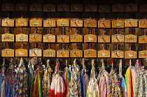 Japan, Kyoyo, Fushimi Inari Taisha shrine, wooden plaques called Ema with requests from worshippers, strings of origami paper cranes as offerings.