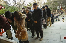 Japan, Tokyo, Shinjuku, Hanazono Jinja shrine, long line of New Years worshippers in line to worship.