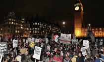 England, London, Anti-War protesters against the bombing of Syria outside the House of Commons carrying Dont Bomb Syria placards.