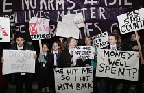 England, London, Anti-War protesters against the bombing of Syria outside the House of Commons carrying Dont Bomb Syria placards.