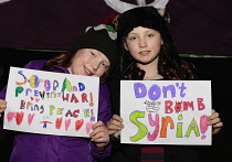 England, London, Anti-War protesters against the bombing of Syria outside the House of Commons carrying Dont Bomb Syria placards.