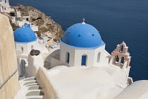 Greece, Santorini, Oia, Anastasi Church in front and Agios Spiridonas Church behind.