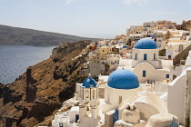Greece, Santorini, Oia, Agios Spiridonas Church in front, and Anastasi Church behind.