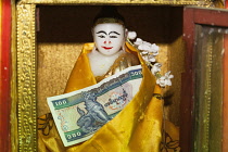 Myanmar, Religious statue and donation at Popa Taung Kalat Temple, Mount Popa, near Bagan.