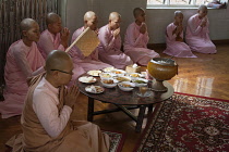Myanmar, Mandalay, Nuns praying before eating, Sakyadhita Thilashin Nunnery School, Sagaing.