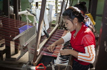 Myanmar, Mandalay, Woman weaving on a loom, Thein Nyo silk weaving workshop, Amarapura.