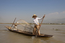 Myanmar, Shan State, Nyaung Shwe,Intha fishermen fishing in a traditional fishing boat, Inle Lake.