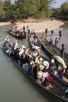 Myanmar, Shan State, Villagers disembarking from boats, Inle Lake, near Indein and Nyaung Ohak villages.