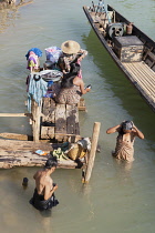 Myanmar, Shan State, Women washing themselves in Inle Lake, near Indein Village.