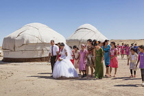 Uzbekistan, Khorezm, Wedding party in front of yurts, Ayaz Kala Yurt Camp, Ayaz Kala.