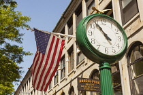 USA, Massachusetts, Boston, Clock and American flag outside Durgin Park Restaurant, Faneuil Hall Marketplace.