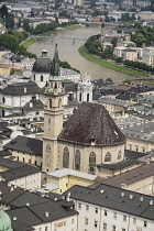 Austria, Salzburg, View of Franziskanerkirche or the Franciscan Church from the Festung Hohensalzburg Fortress with River Salzach behind.