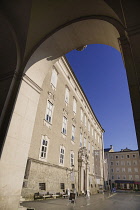 Austria, Salzburg, Residenz Palace, View of the  facade through an arch.