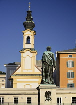 Austria, Salzburg, Michaelskirche or St Michael's Church with Wolfgang Amadeus Mozart statue.