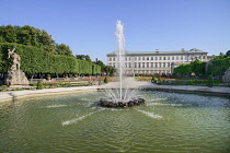 Austria, Salzburg, Mirabell Palace and Gardens with active fountain in the foreground.