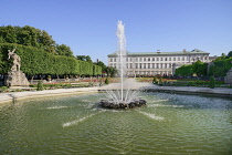 Austria, Salzburg, Mirabell Palace and Gardens with active fountain in the foreground.