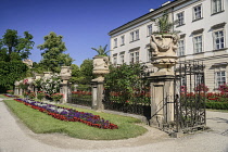 Austria, Salzburg, Mirabell Palace fronted by urns and flower beds.