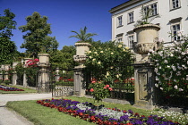 Austria, Salzburg, Mirabell Palace fronted by urns and flower beds.