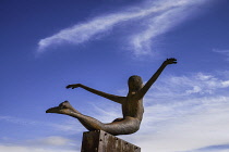 Ireland, Belfast, Titanic Quarter, Titanic Belfast Visitor Experience, 'Titanica' sculpture by Rowan Gillespie with blue sky in the background.