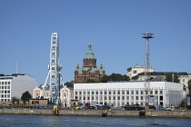 Helsinki. Finland. Uspenski Russian Orthodox Cathedral with Finnair Sky Wheel in the foreground.