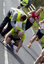 Sport, Athletics, Running, Exhausted runner being helped by marshal.