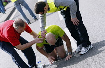 Sport, Athletics, Running, Exhausted runner being helped by marshal.