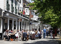 England, Kent, Tunbridge Wells, People sat outside cafe in the Pantiles.