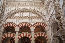 Spain, Andalucia, Cordoba, Detail of the lower part of the Capilla Mayor of the Mezquita Cathedral and arches of the Hypostyle Hall.