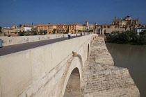 Spain, Andalucia, Cordoba, The Roman Bridge over the Guadalquivir River with the Mezquita Cathedral in the background to the left.