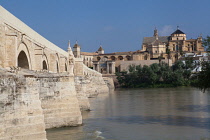 Spain, Andalucia, Cordoba, The Roman Bridge over the Guadalquivir River with the Mezquita Cathedral in the background to the right.