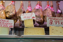 Spain, Andalucia, Granada, Display of cheese and jamon at a stall in the Mercado de San Agustin.