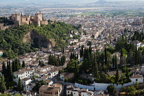 Spain, Andalucia, Granada, Panorama of the Alhambra and Albayzin district with Granada city in the background from the viewpoint at Iglesia de San Miguel.
