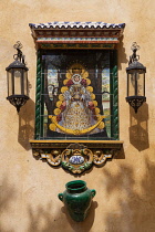 Spain, Andalucia, Seville, Ceramic tiled image of the Virgin Mary in the courtyard of the church of Colegial Divino Salvador.