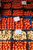 Spain, Andalucia, Seville, Display of tomatos and potatosl at the Mercado de la Feria Feria Market.
