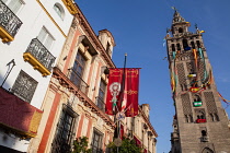 Spain, Andalucia, Seville, The Giralda of Seville Cathedral with banners and streamers hanging from the bell  tower to celebrate the feast of Corpus Christi.