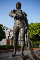 Spain, Andalucia, Seville, Statue  of the matador Curro Romero outside the Plaza de Torres.